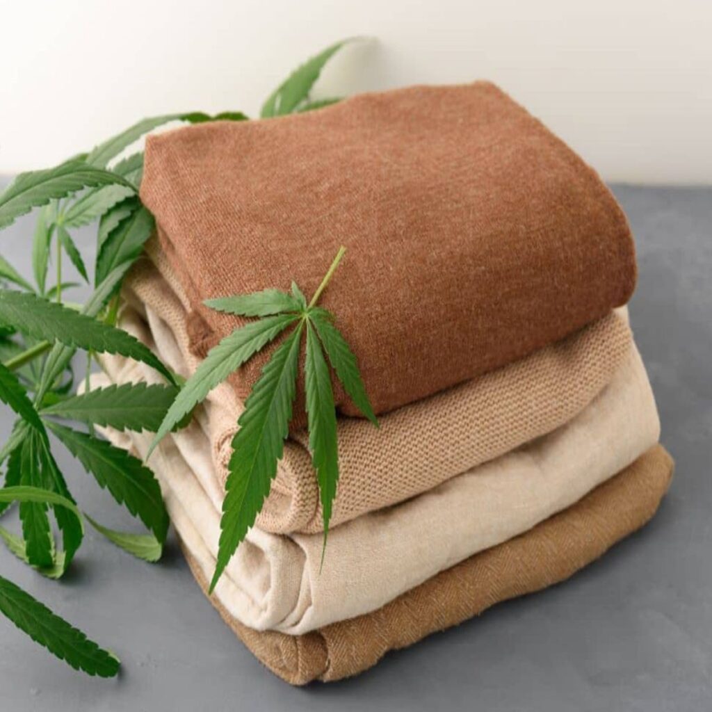 Hemp fabric folded on a table with hemp leaves decorating the area